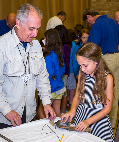 Brotherhood member helping a student make her shofar