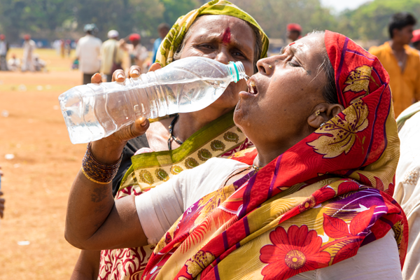 Women drinking from water bottle.png